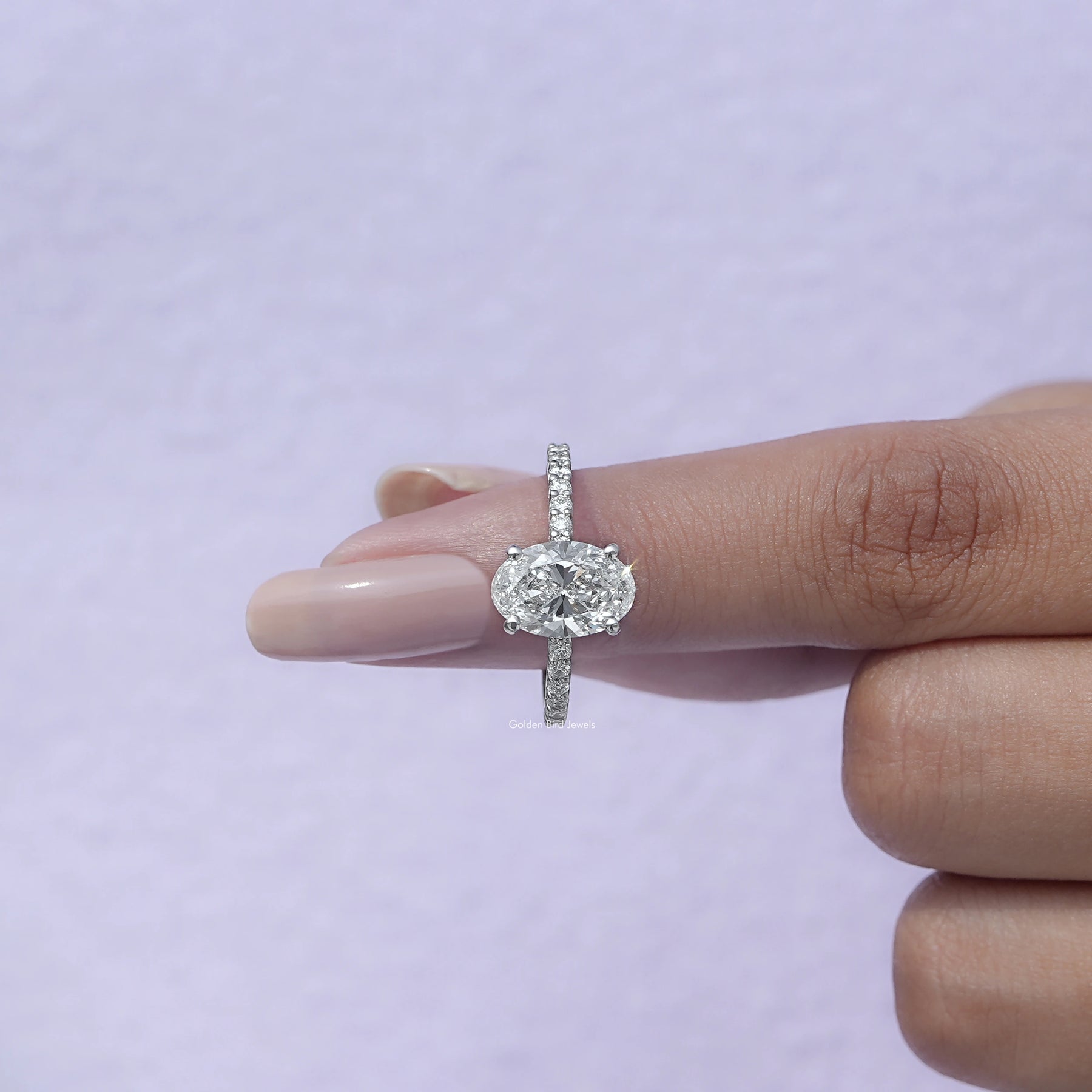 In finger front view of Oval Cut Diamond Ring With Round Accents