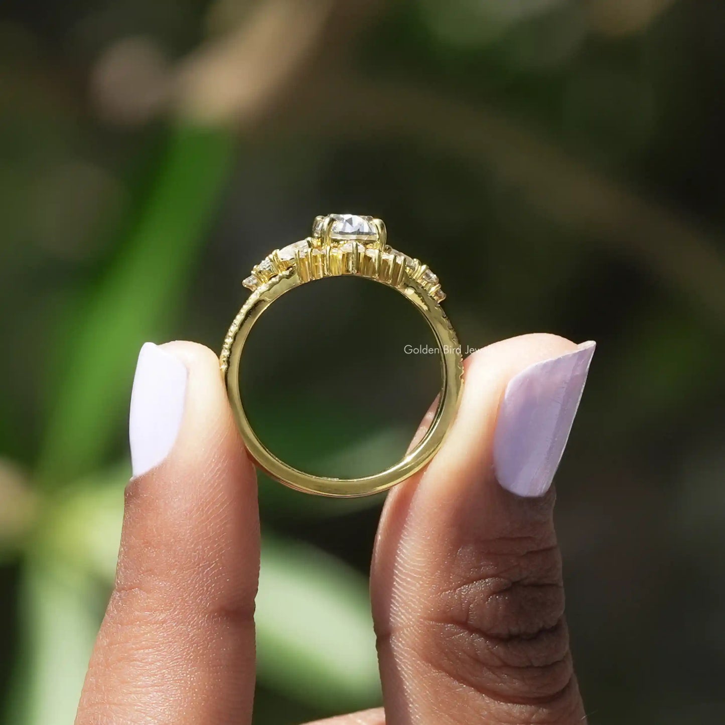 Back View of Oval Cut Moissanite Accent Stone Ring In two fingers