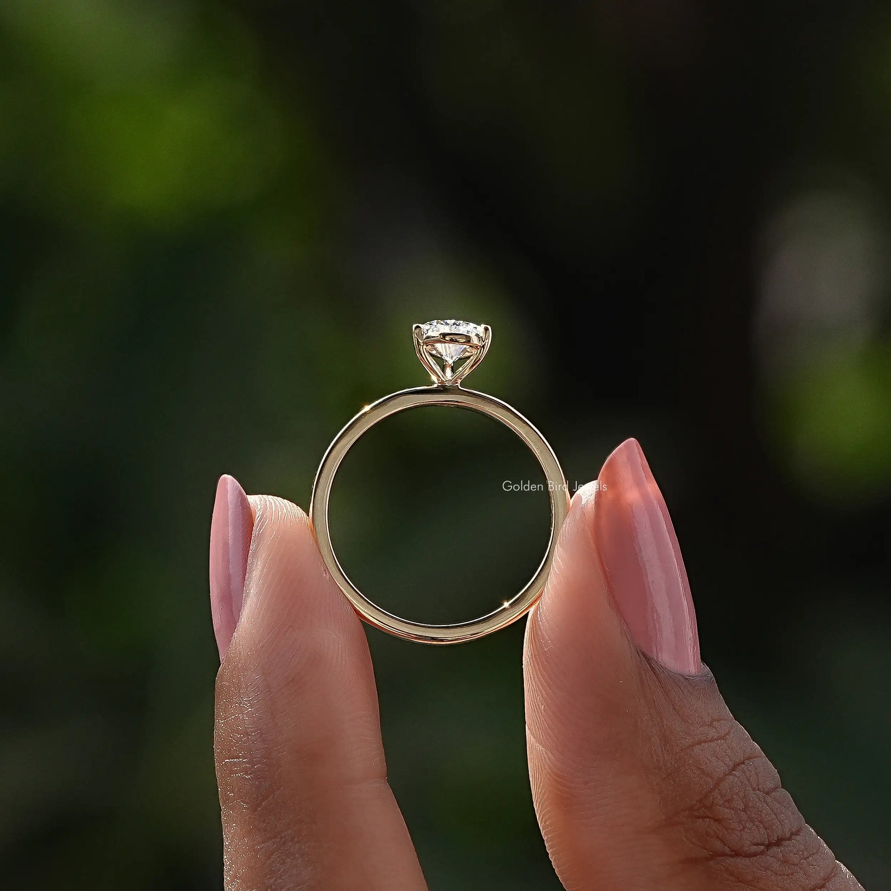 Back View of Pear Shaped Solitaire Ring In two fingers