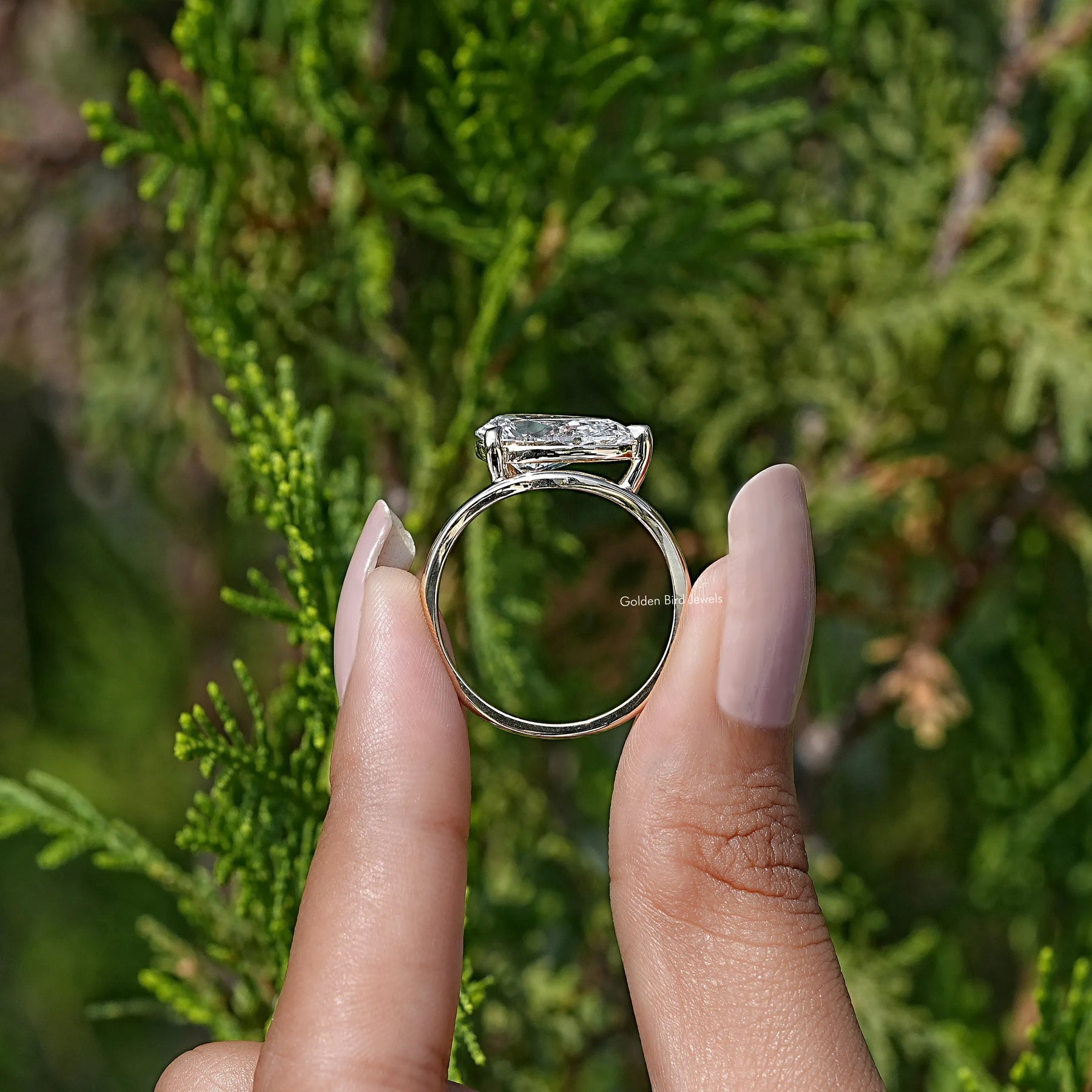 Back view of Pear Lab Diamond Curved Solitaire Ring in secure setting 
