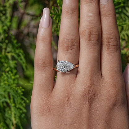 In finger view of Pear Lab Diamond Curved Solitaire Ring
