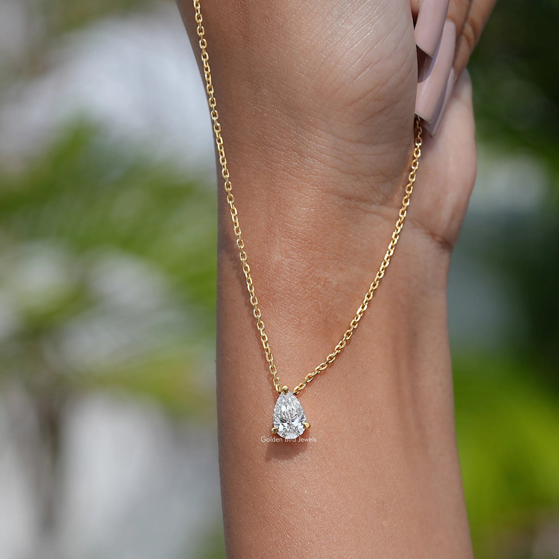 In hand showing view of diamond  solitaire pendant