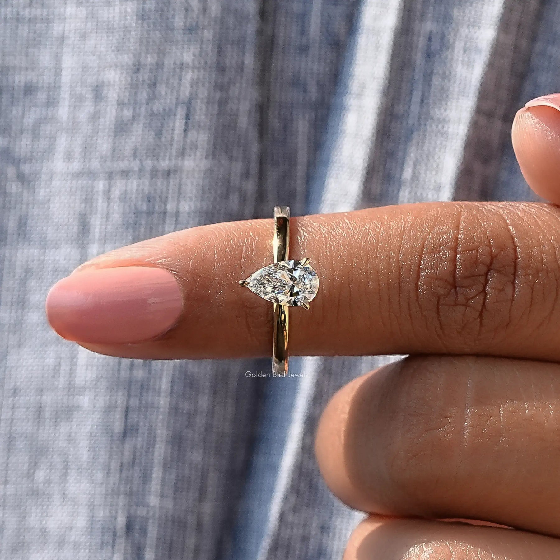 In finger front View of Pear Cut Diamond Solitaire Ring