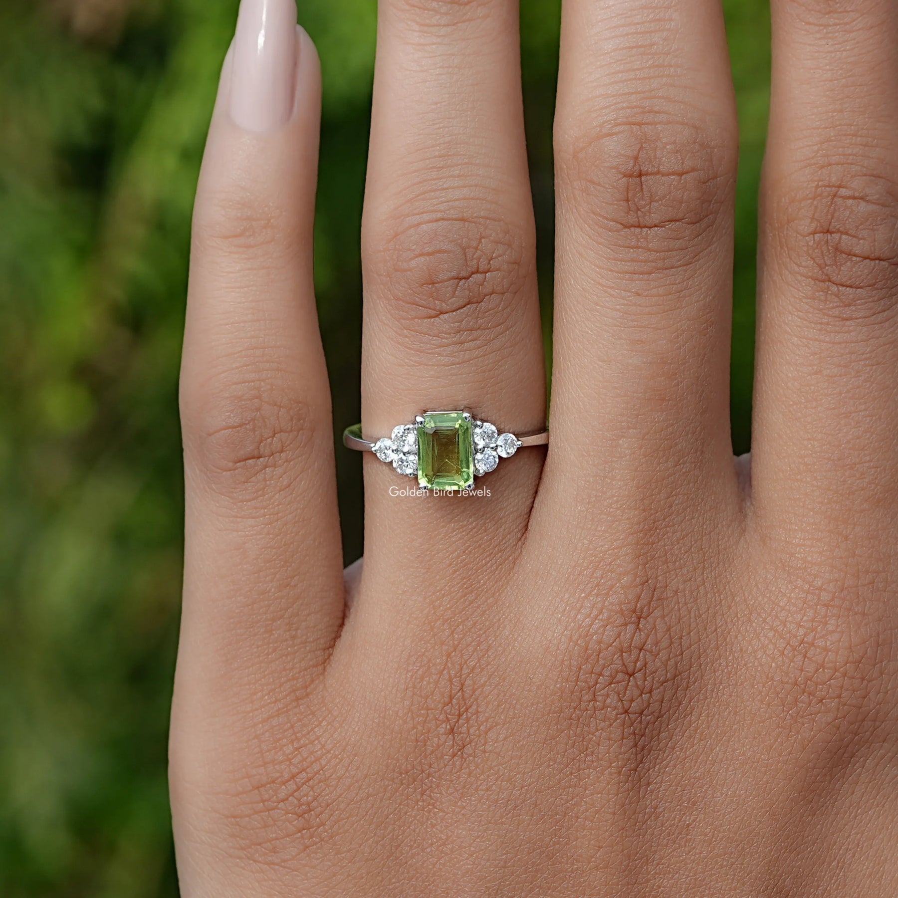 View of Green Emerald Cut Gemstone Ring In White Gold