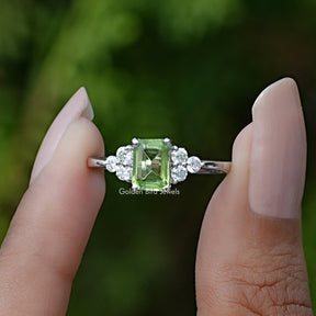 Front View of Peridot Green Emerald Gemstone Ring In two Fingers