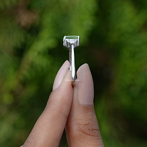 Side View of Peridot Green Emerald Gemstone Ring  In two fingers