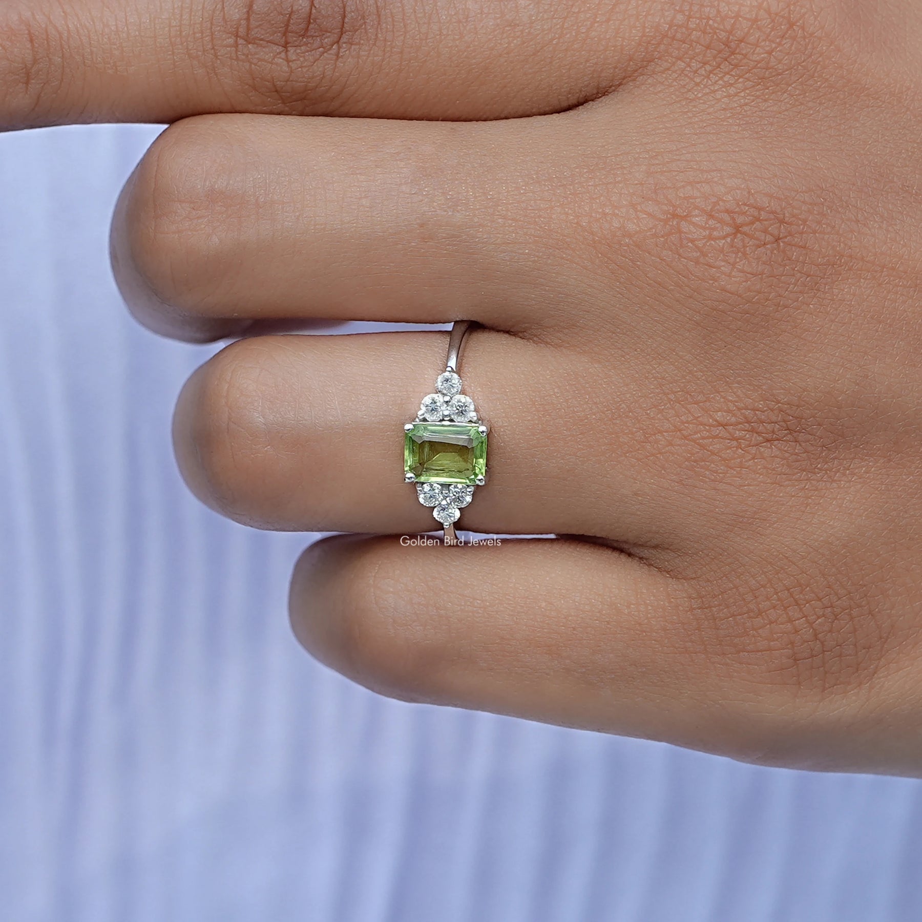 Close-Up View of Peridot Green Gemstone Emerald Cut Ring In White Gold