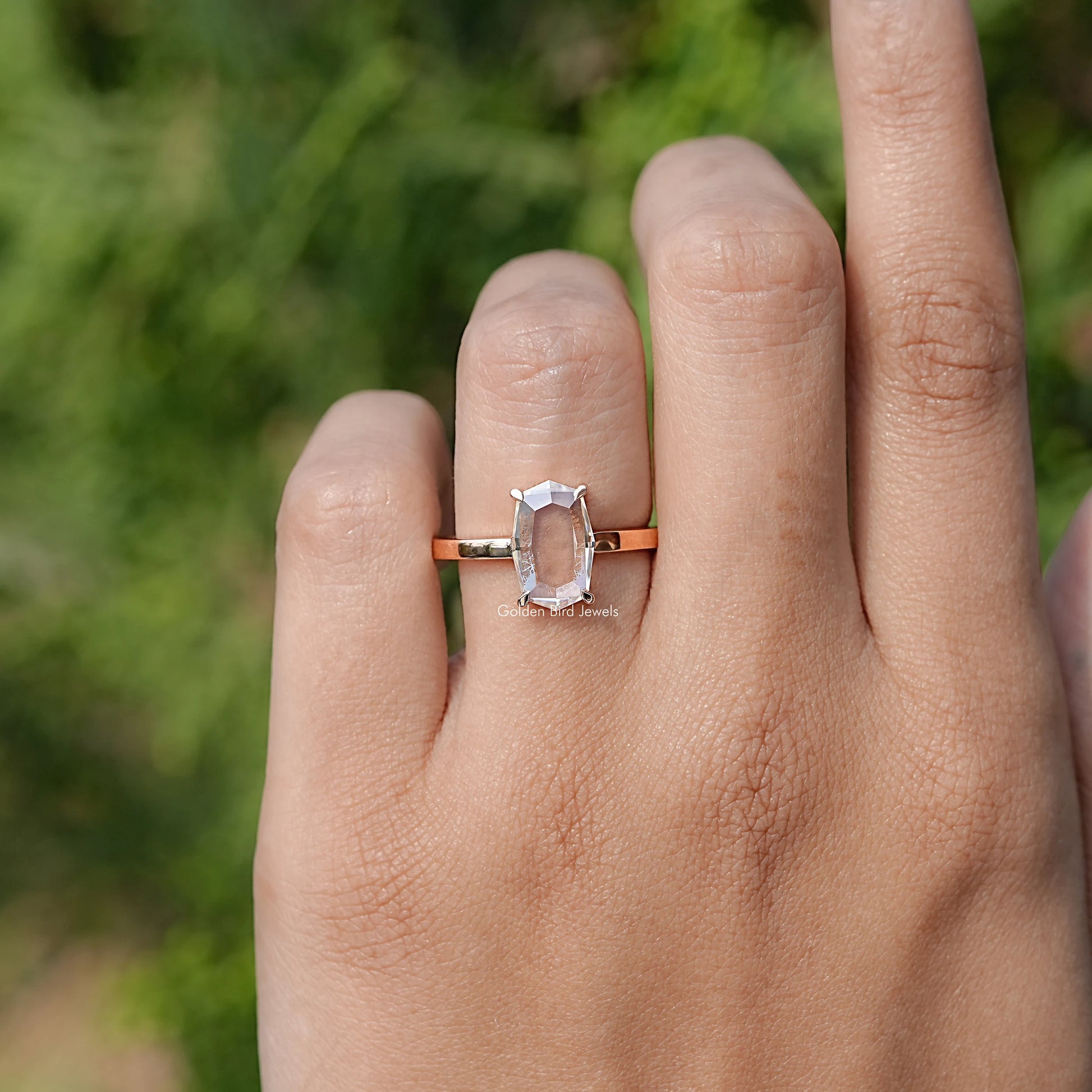 In finger front view of Portrait Cut Hexagon Moissanite Ring