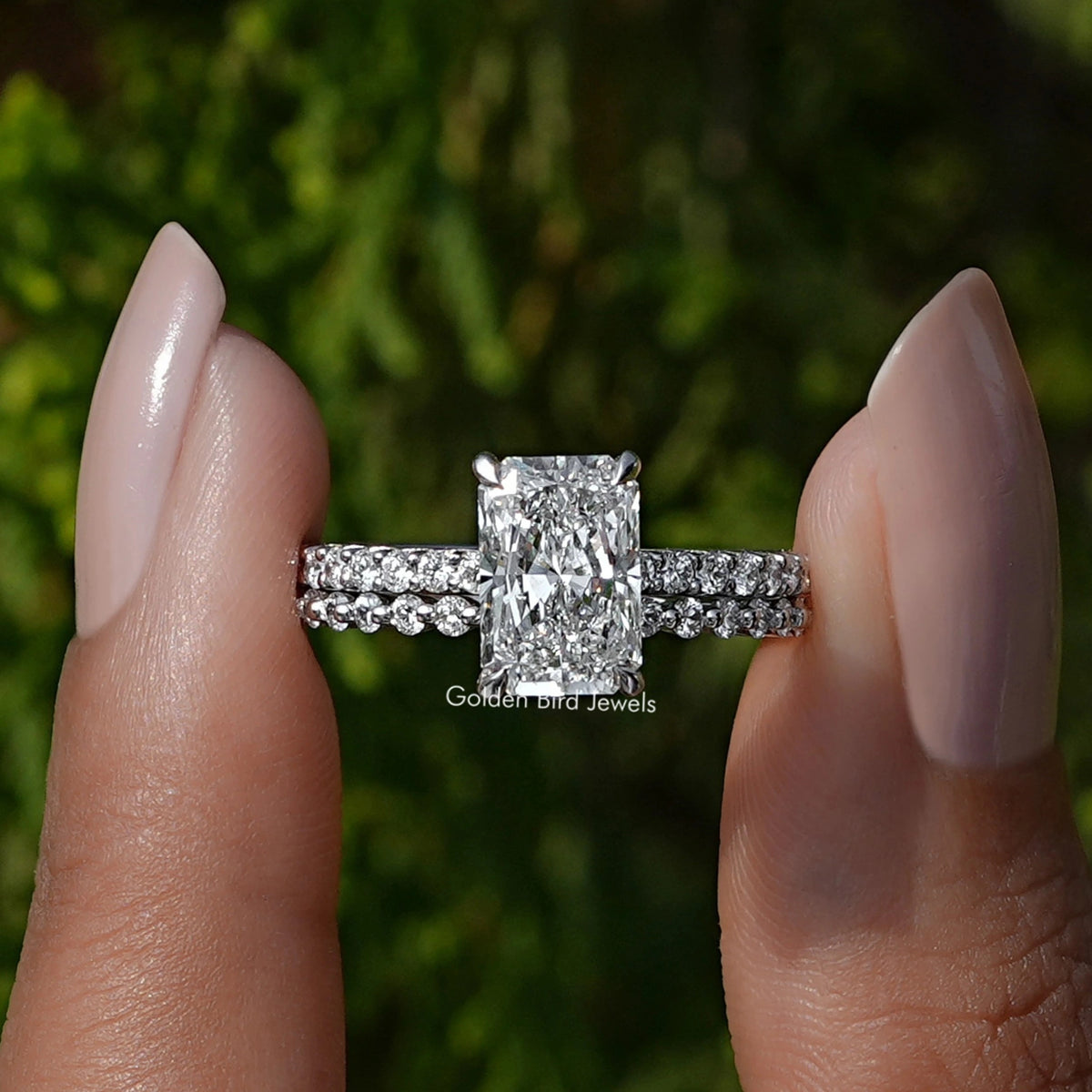 Front view A Radiant Cut Diamond Bridal Ring Set in a two fingers
