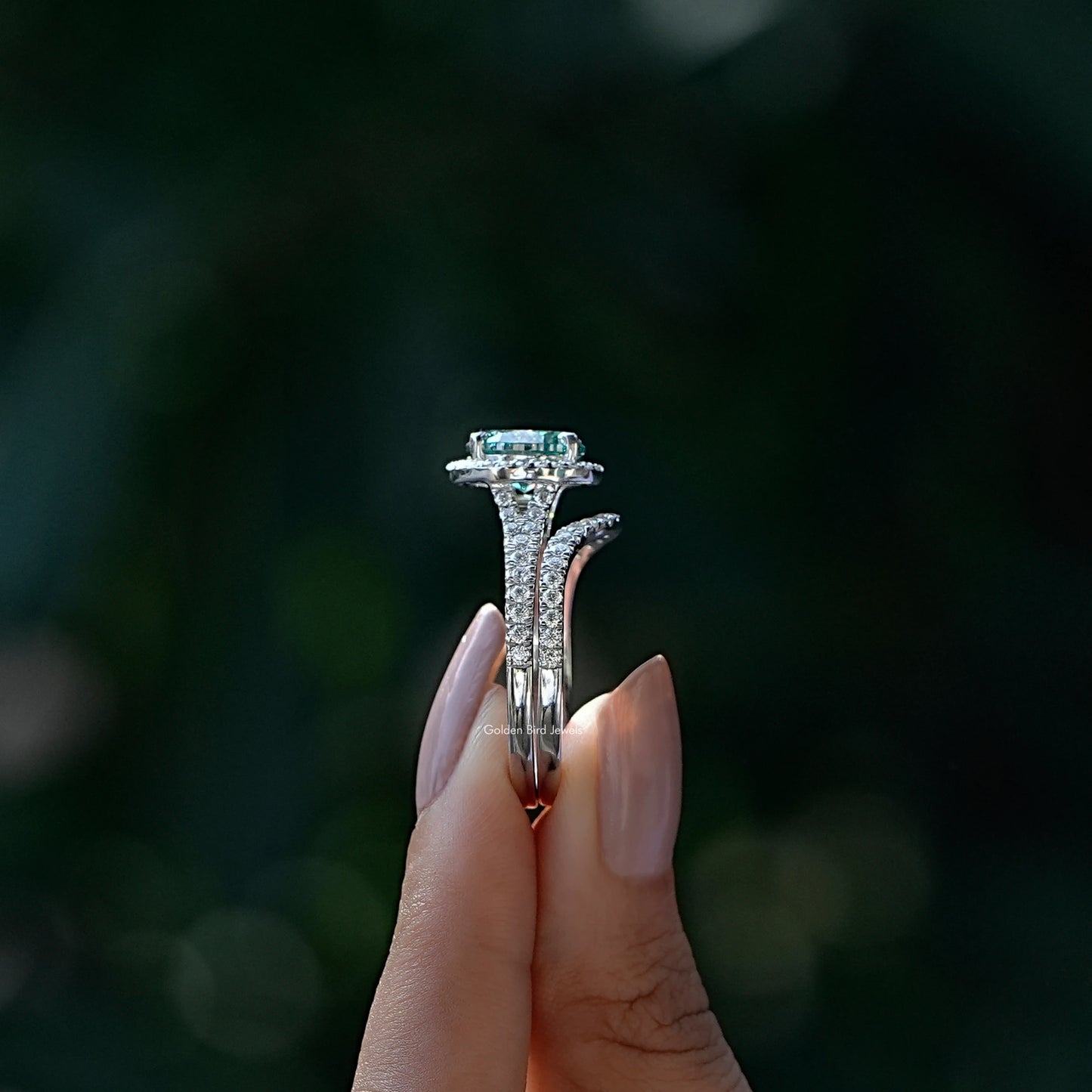 Side View of Round And Oval Cut Bridal Ring Set In two fingers