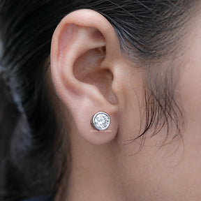 Side View of Round Cut Diamond Bezel Stud Earrings on Ear