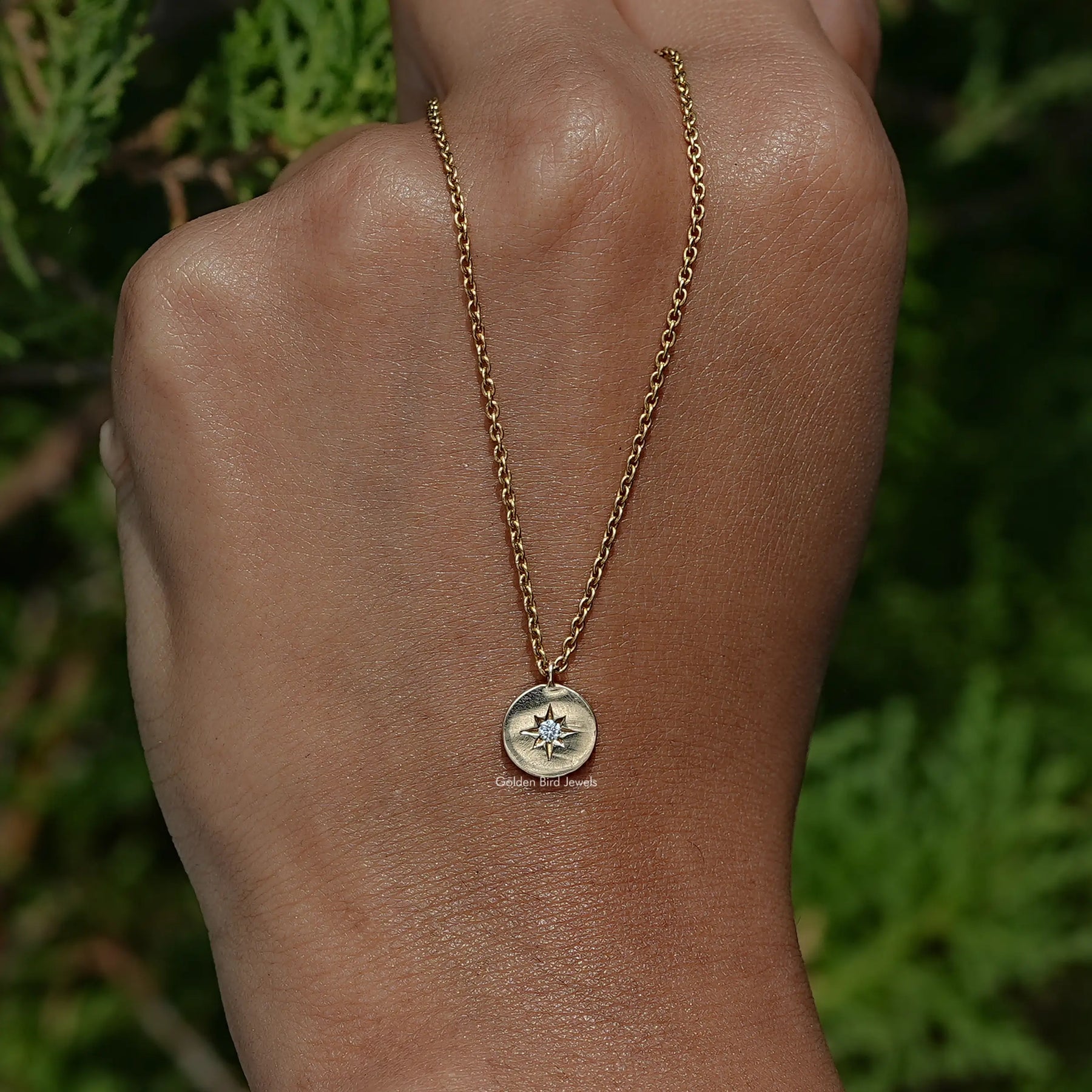 In Hand Holding the Round Cut Lab Diamond Pendant