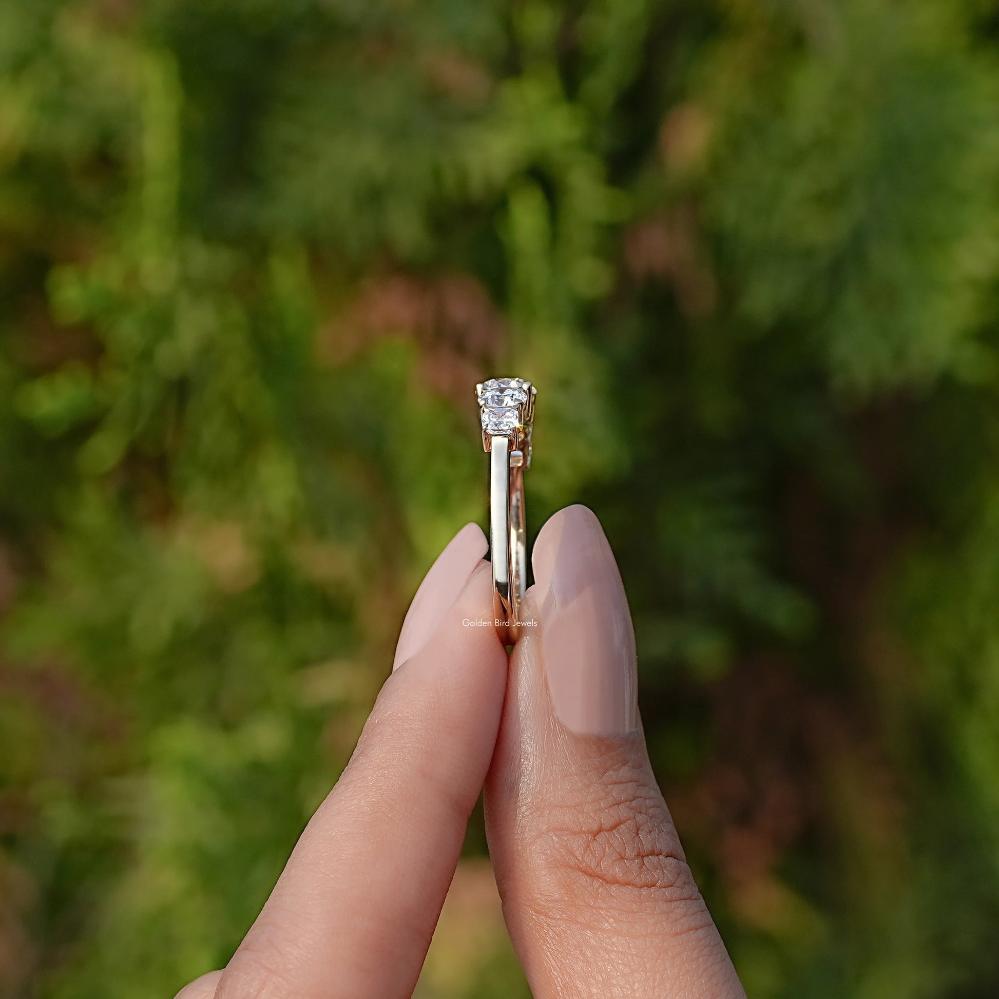 Side View of Round Cut Lab Grown Diamond Ring In two fingers