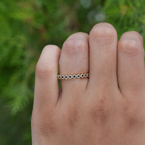 In finger front view of round cut gemstone ring