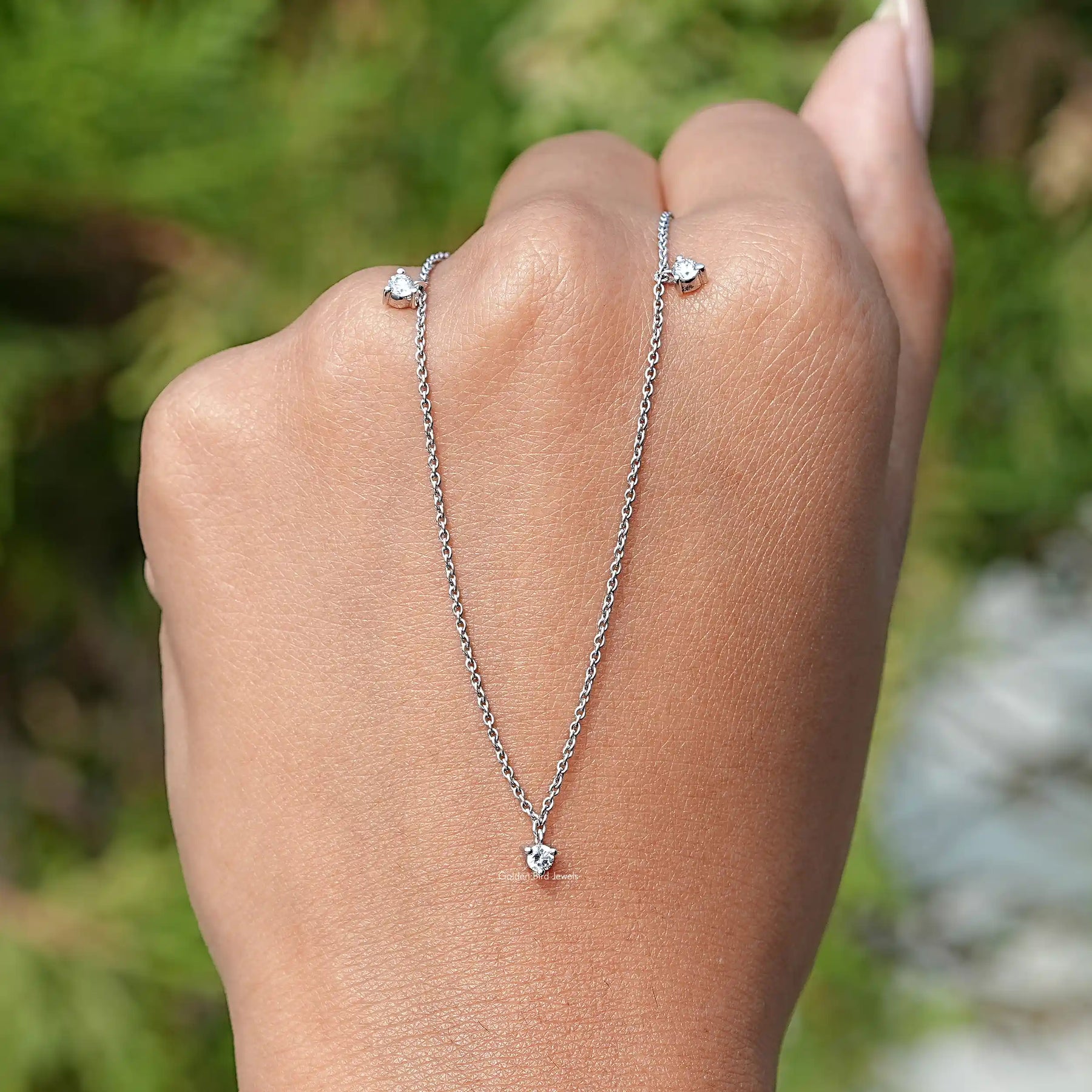 In Hand Holding the Round Cut Diamond Necklace