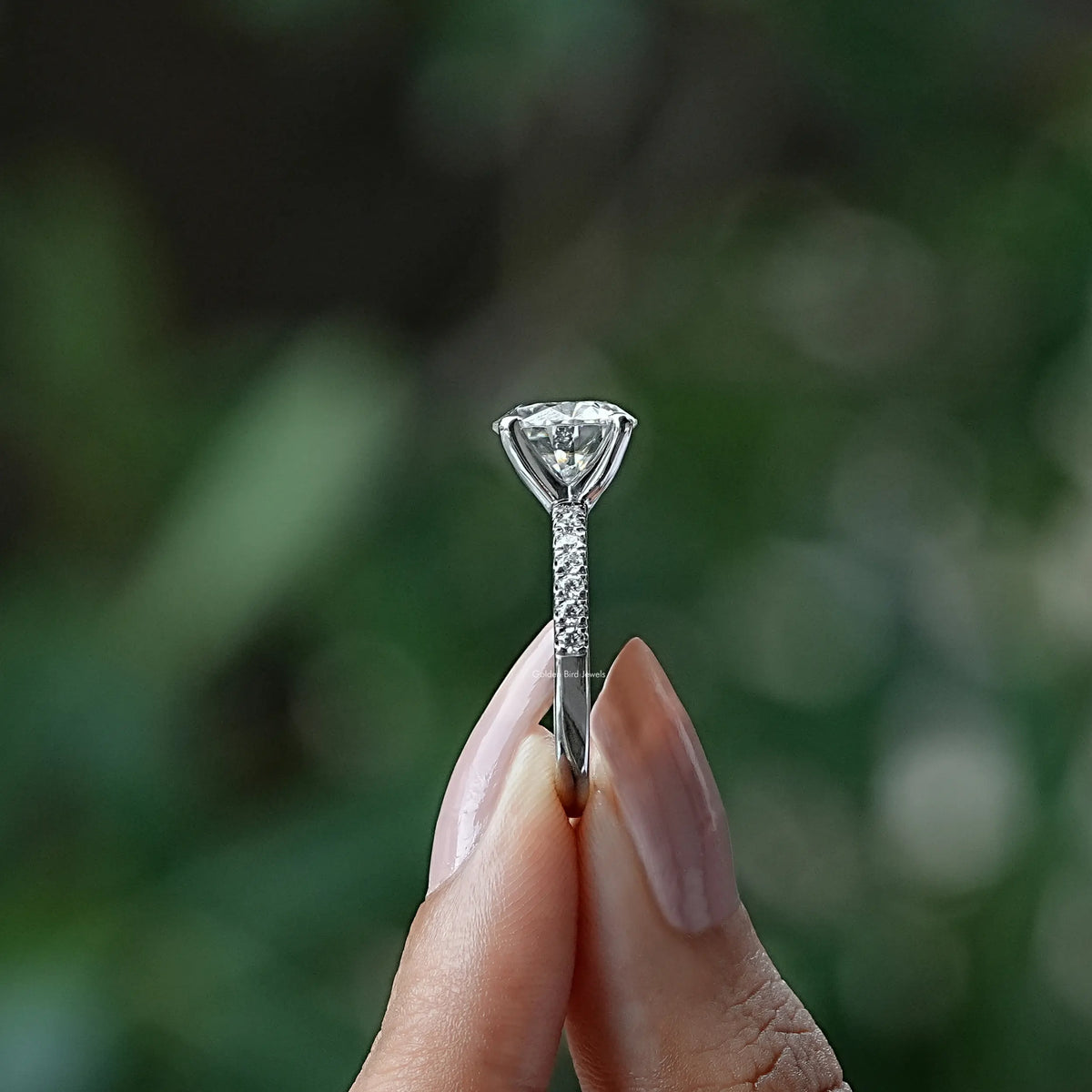 Side View of Round Cut Moissanite Solitaire Ring In two fingers