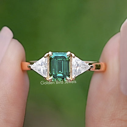 Front view of Emerald And Triangle Moissanite Three Stone Ring 