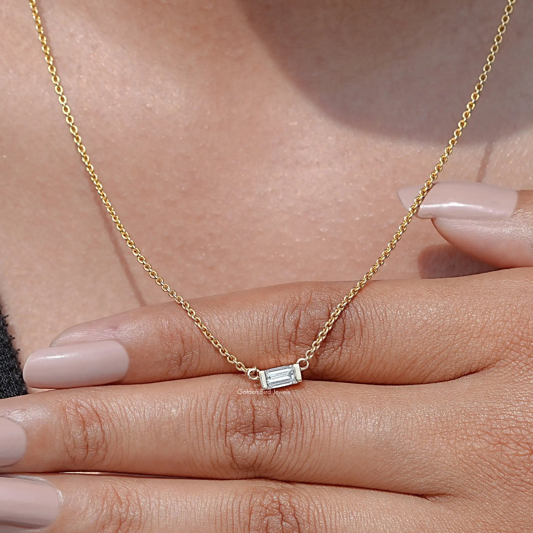 Close-Up View of Baguette Cut Solitaire Diamond Pendant In Yellow Gold