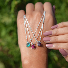 In hand holding the Round Cut Gemstone Solitaire Pendant