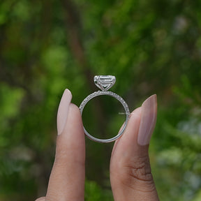 Back View of Emerald Cut Diamond Engagement Ring In two fingers