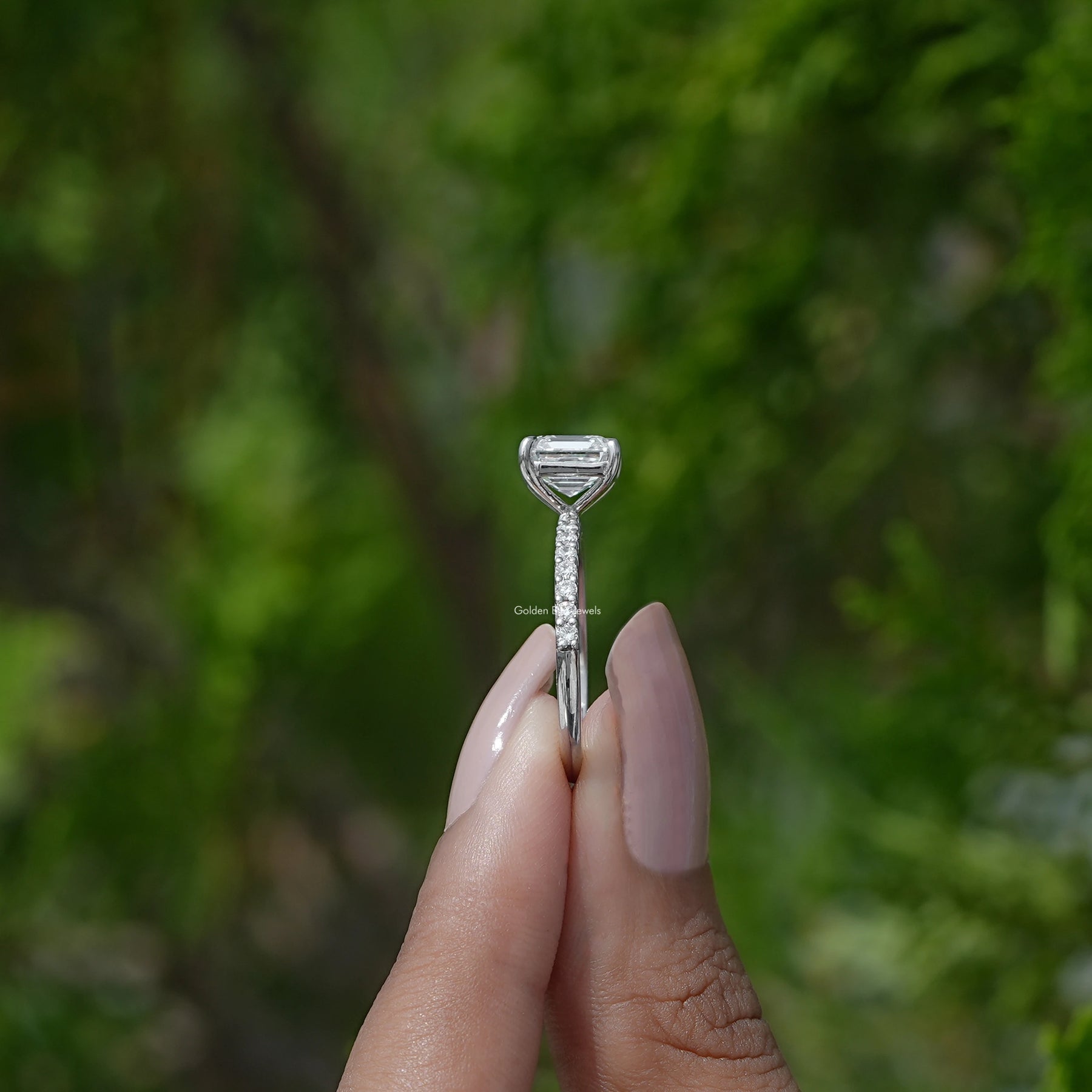 Side View of  Square Emerald Diamond Engagement Ring on two fingers