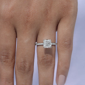 Close-up View of Emerald Diamond Engagement Ring on finger