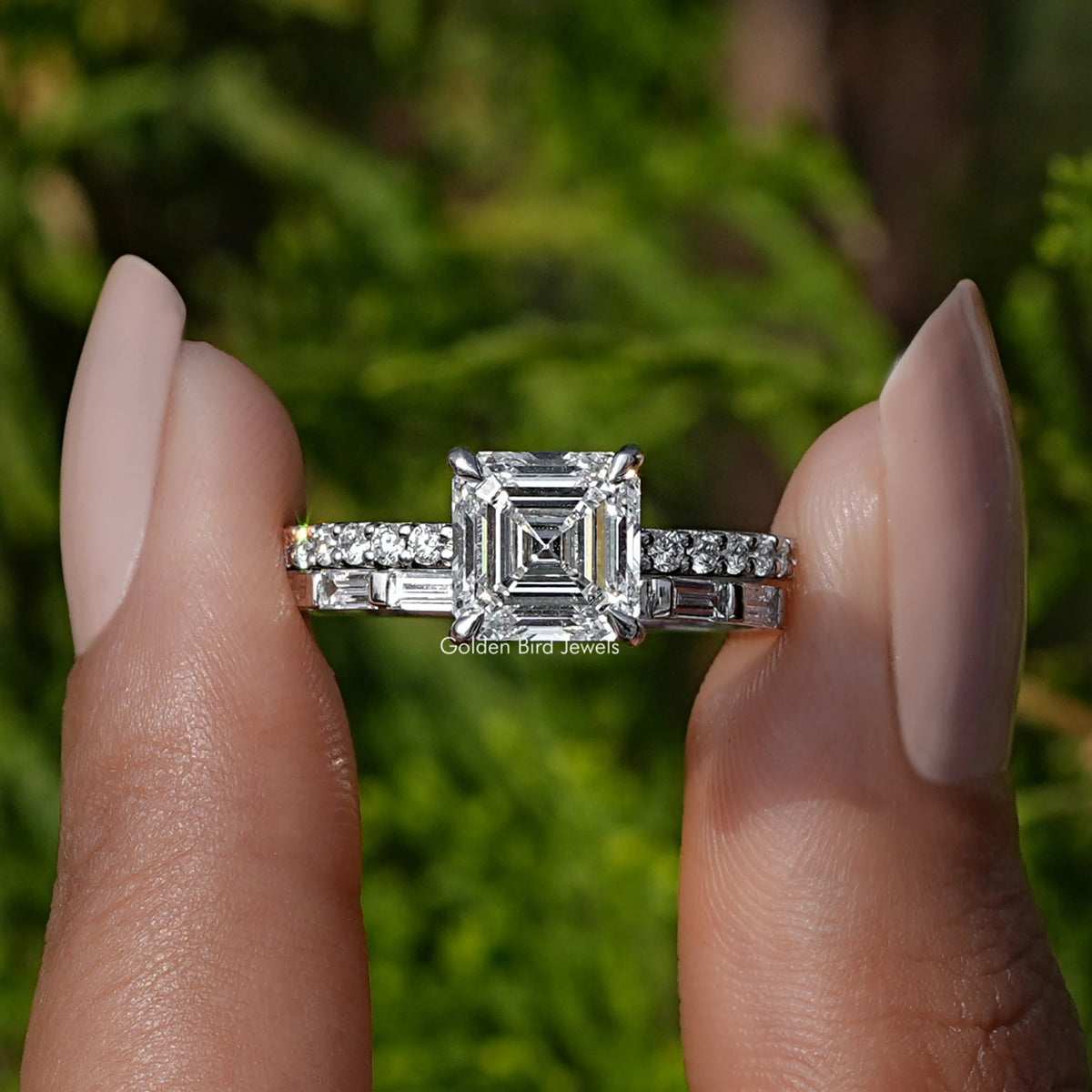 Front View A Emerald Cut Lab Diamond Wedding Ring Set In two fingers
