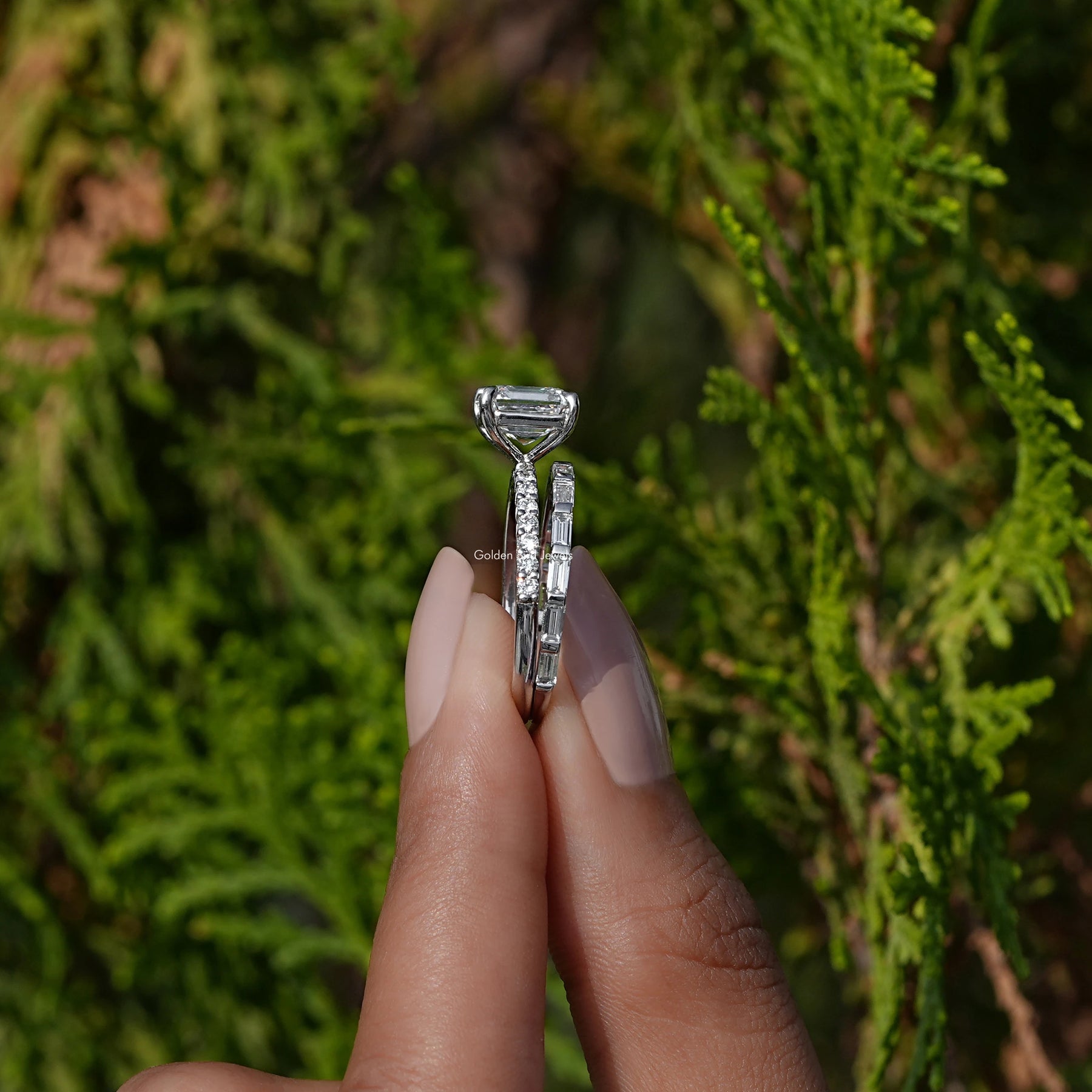 Side View A Emerald Cut  Diamond Wedding Ring Set in two fingers