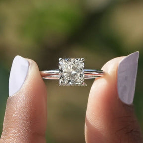 Two fingers holding the Square Radiant Cut Lab Diamond Solitaire Ring