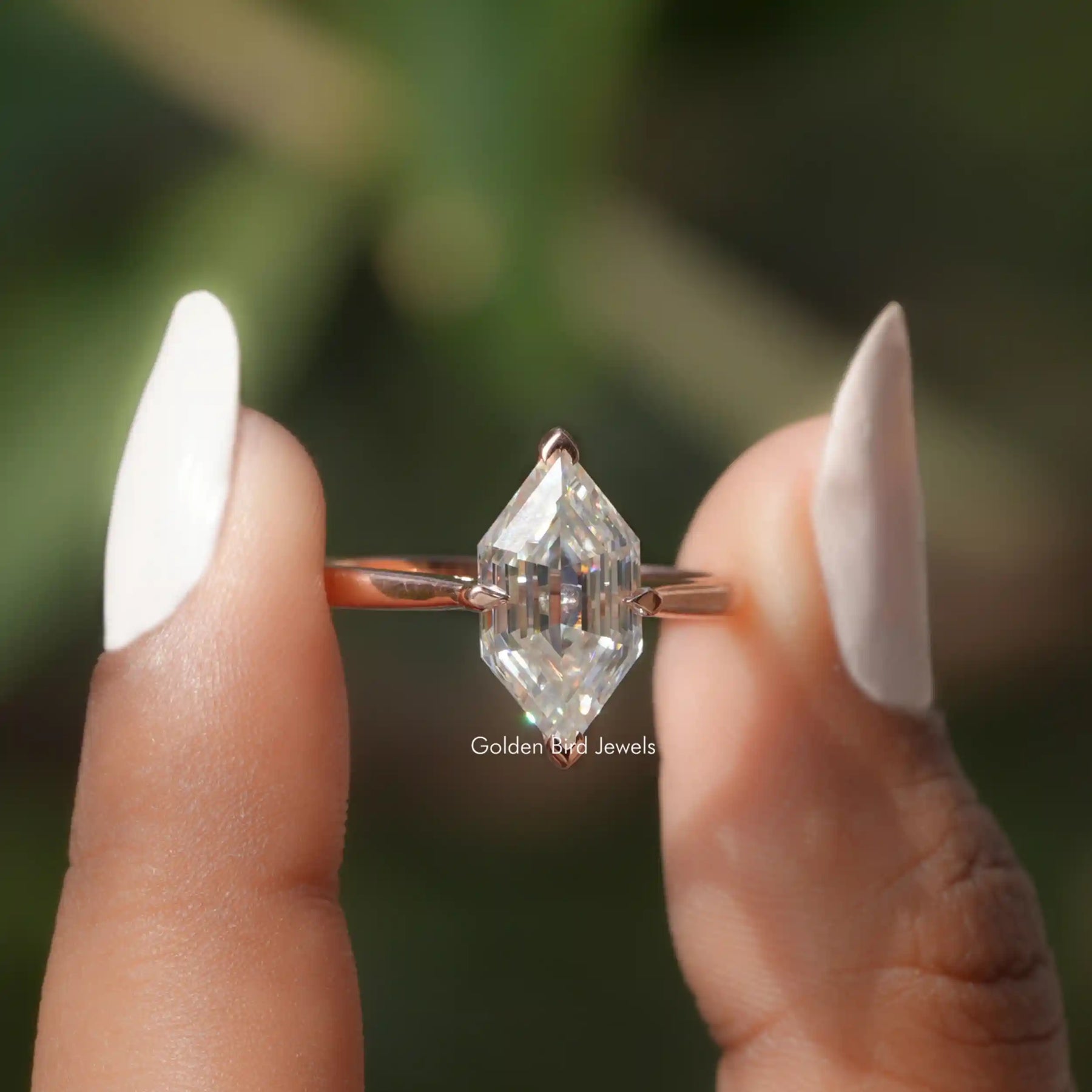 Step Cut Dutch Marquise Ring held between two fingers