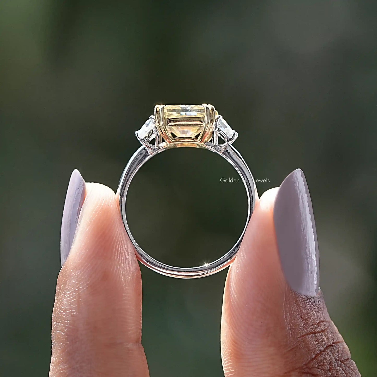 Back View of Radiant Cut Moissanite 3 Stone Ring In two fingers
