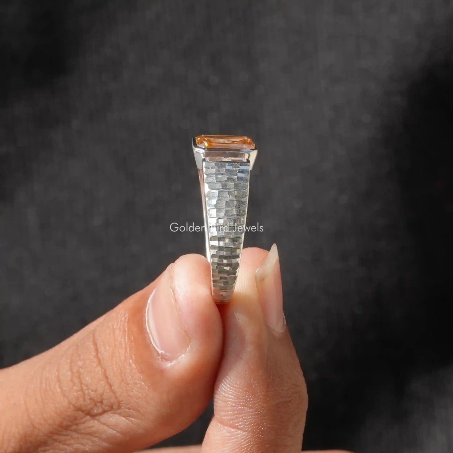 Side View of Criss Cut And Baguette Moissanite Ring In two fingers
