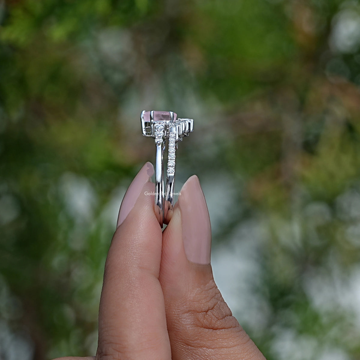 Side View of Blue Topaz Gemstone Halo Ring In two fingers