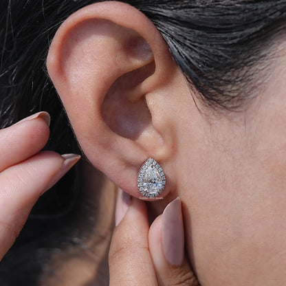 Close-Up View of Pear Cut Moissanite Halo Stud Earrings In Women's Ear's