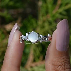 Front View of White Moonstone Round Gemstone Solitaire Ring In two Fingers